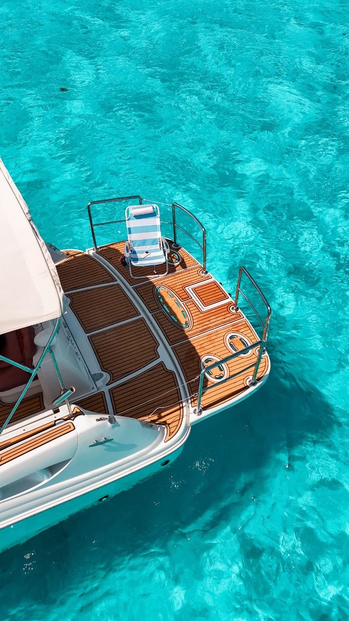 Teak deck of a yacht anchored in Cozumel’s turquoise waters